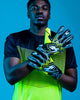 Person wearing Kaliaaer Ignite yellow Goalkeeper Gloves